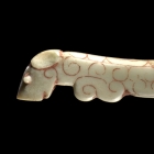 AN ARCHAIC JADE DRAGON PENDANT