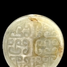 AN ARCHAIC JADE DISC SHAPE BEAD