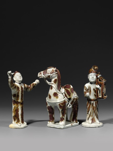 THREE IRON-BROWN SPLASHED QINGBAI GLAZED PORCELAIN FIGURES