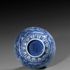 A MING REVERSE-DECORATED BLUE AND WHITE PORCELAIN ‘DRAGON’ BOWL