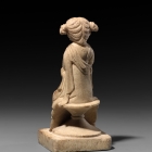 A WHITE MARBLE FIGURE OF A COURTESAN