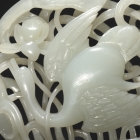 A WHITE JADE OPENWORK ‘GOOSE IN LOTUS’ PLAQUE