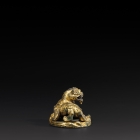 A GILT BRONZE ‘QILIN’ MAT WEIGHT