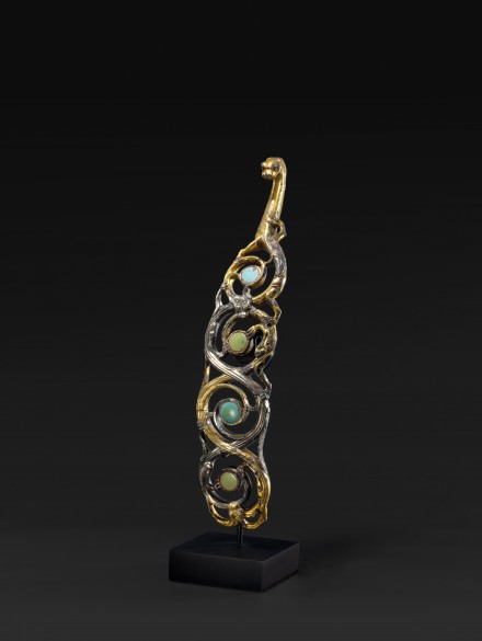 AN OPENWORK TURQUOISE INLAID GILDED AND SILVERED BRONZE BELTHOOK