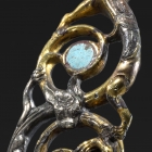 AN OPENWORK TURQUOISE INLAID GILDED AND SILVERED BRONZE BELTHOOK