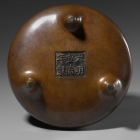 A BRONZE ‘GOLDEN MIST’ INCENSE BURNER AND STAND