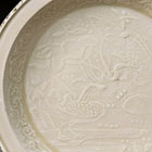 A MOULDED DINGYAO WHITE PORCELAIN ‘DUCKS-IN-LOTUS-POND’ DISH