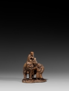 AN IMPERIAL BOXWOOD CARVING OF MANJUSHRI SEATED ON A LION